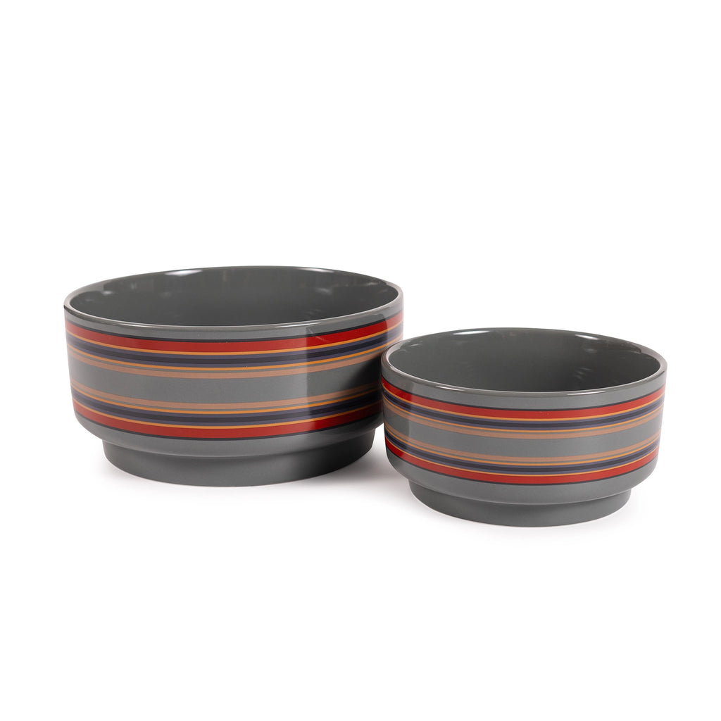 Two gray bowls with red and orange stripes on a white background